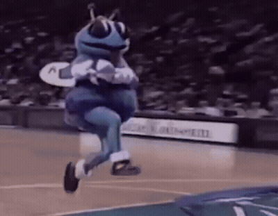 A Mascot Is Jumping In The Air On A Basketball Court . GIF