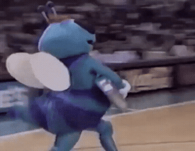 A Mascot Is Playing Basketball On A Court . GIF