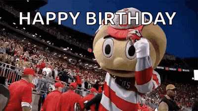 A Mascot Is Standing In Front Of A Crowd In A Stadium And Says Happy Birthday . GIF