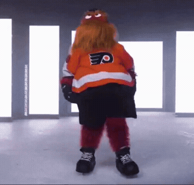 A Mascot Is Standing On A Ice Rink Wearing A Jersey With The Letter P On It . GIF