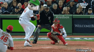 A Mascot Is Swinging A Bat At A Baseball Game GIF