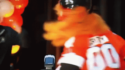 A Mascot Is Wearing A Red Jersey With The Number 60 On It GIF