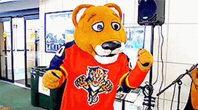 A Mascot Is Wearing An Orange Shirt With A Tiger On It GIF
