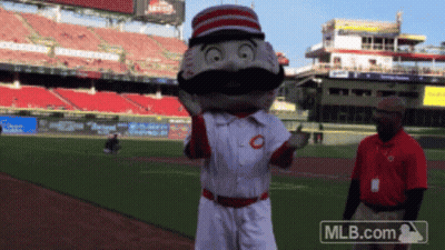 A Mascot On A Baseball Field With A Mlb.com Logo In The Background GIF