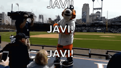 A Mascot On A Baseball Field With The Words Javi Above Him GIF