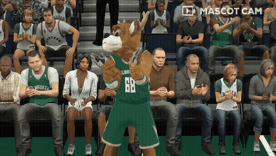 A Mascot Wearing A Number 68 Jersey Stands In Front Of A Crowd GIF