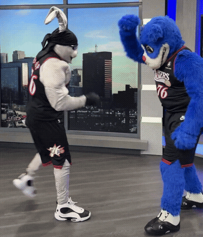 A Mascot Wearing A Number 76 Jersey Stands Next To A Bunny Mascot GIF