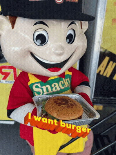 A Mascot Wearing A Snack Shirt Holds Up A Hamburger GIF