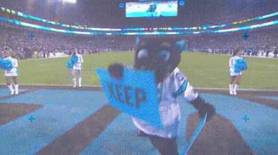 A Mascot With A Sign That Says Keep On It GIF