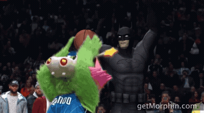 A Mascot With The Number 2000 On His Jersey Is Standing Next To A Batman GIF