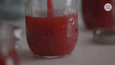 A Mason Jar Filled With Red Liquid Has The Number 300 On The Side GIF