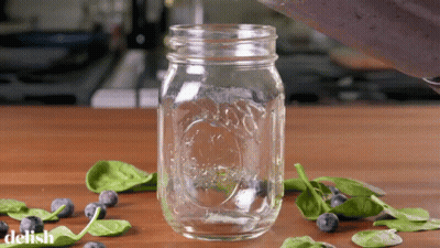 A Mason Jar With The Word Delish Written On The Bottom GIF