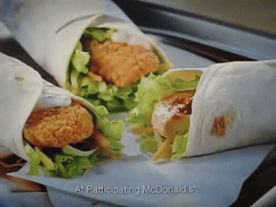 A Mcdonald 'S Advertisement Shows Two Wraps With Chicken And Lettuce GIF