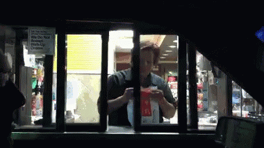 A Mcdonald 'S Drive Thru Window With A Sign That Says " We Do Not Accept Cash " GIF