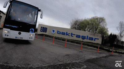 A Mercedes Bus Is Driving Past A Sign That Says Bektaslar GIF