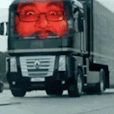 A Mercedes Truck With A Red Face On The Front GIF