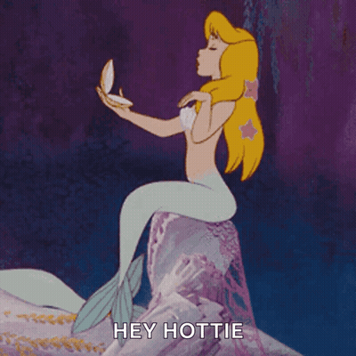 A Mermaid Is Sitting On A Rock Holding A Pearl And Says Hey Hottie GIF