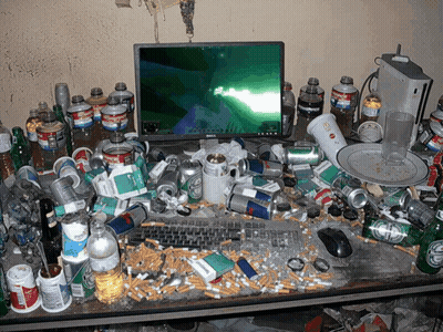 A Messy Desk With A Dell Monitor And Coca Cola Bottles GIF