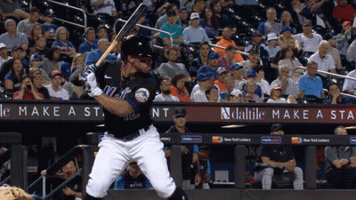 A Mets Baseball Player Swings At A Pitch GIF