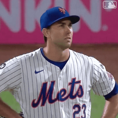 A Mets Baseball Player Wearing A Blue Hat And Jersey GIF
