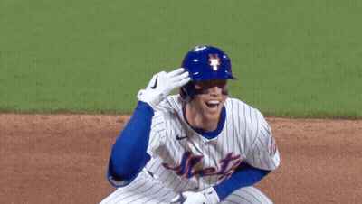 A Mets Baseball Player Wearing A Blue Helmet And White Jersey GIF