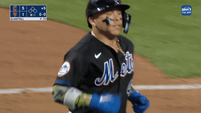 A Mets Baseball Player Wearing A Helmet And A Chain Around His Neck GIF