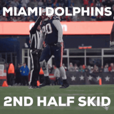 A Miami Dolphins Football Player Celebrates With A Referee GIF
