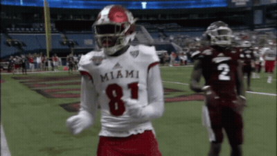 A Miami Football Player Wearing Number 81 Is Dancing On The Field GIF