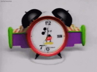 A Mickey Mouse Alarm Clock Shows That It Is 7:46 GIF