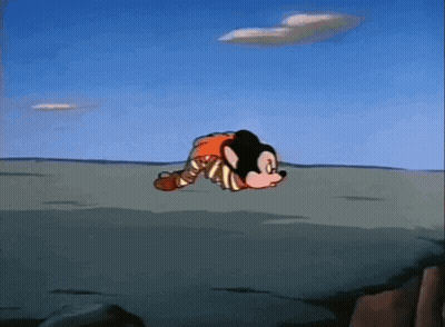 A Mickey Mouse Cartoon Character Is Laying On The Ground GIF