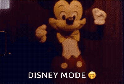 A Mickey Mouse Doll Is In Disney Mode On A Red Background GIF