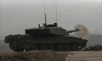 A Military Tank With The Number 14 On It GIF