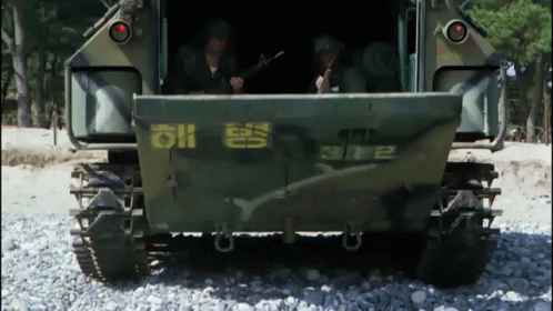 A Military Vehicle Has The Number 2 On The Back GIF