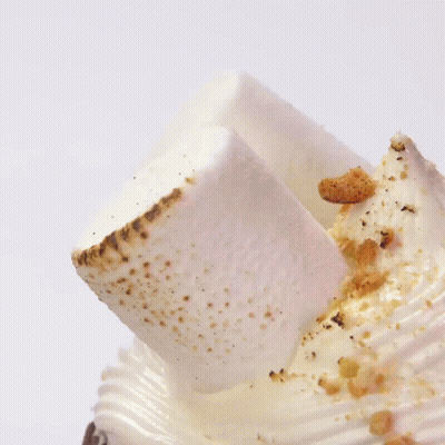 A Milkshake With Chocolate And Whipped Cream On Top Of It GIF