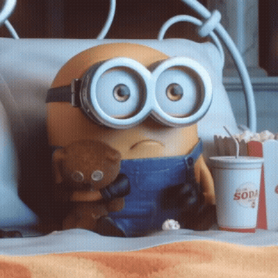 A Minion Holding A Teddy Bear Next To A Cup That Says Soda On It GIF