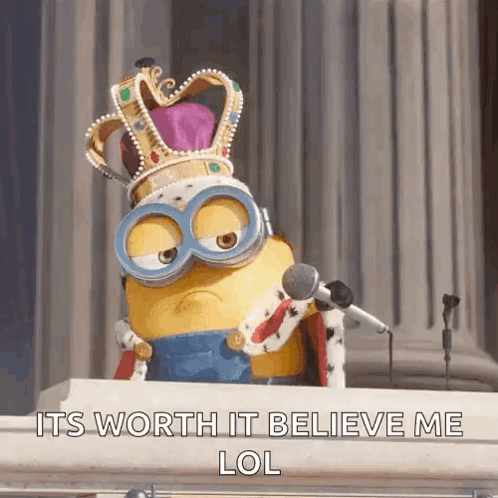 A Minion Wearing A Crown And Goggles Is Sitting At A Podium With A Microphone .. GIF
