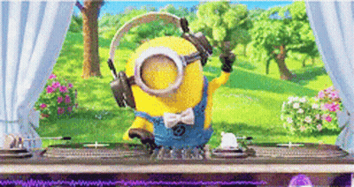 A Minion Wearing Headphones And Goggles Is Standing In Front Of A Table . GIF