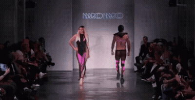 A Model Walks Down A Runway At A Fashion Show Sponsored By Marco Marco GIF