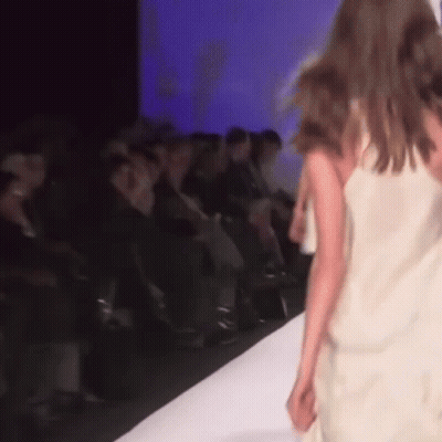 A Model Walks Down The Runway At A Fashion Show . GIF