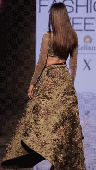 A Model Walks Down The Runway At A Fashion Week GIF
