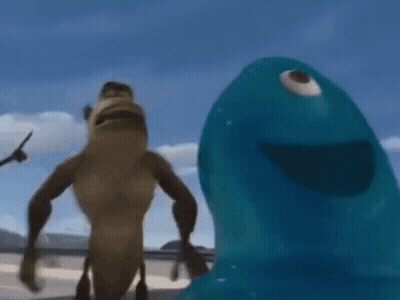 A Monkey And A Blue Monster Are Standing Next To Each Other On A Beach . GIF
