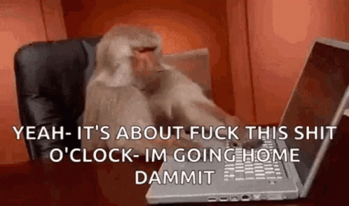 A Monkey Is Sitting At A Desk Typing On A Laptop . GIF