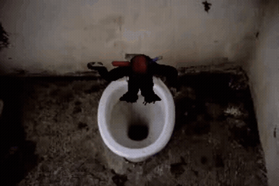 A Monkey Is Sitting On A Toilet With A Toothbrush . GIF