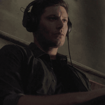 A Monkey Is Wearing Headphones And Holding A Microphone In Its Hand . GIF