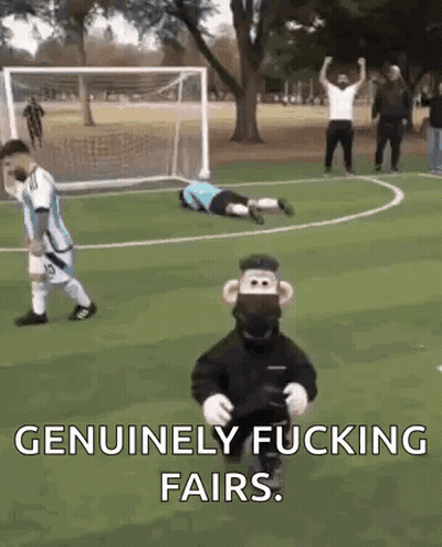 A Monkey Mascot Is Standing On A Soccer Field Next To A Goalie . GIF
