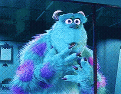 A Monster From The Movie Monsters Inc Is Standing In Front Of A Chain Link Fence GIF