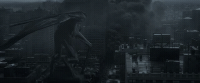 A Monster Is Standing In The Middle Of A City With Smoke Coming Out Of It 'S Mouth GIF