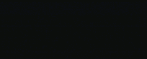 A Monster With Large Teeth Is Standing In The Dark GIF
