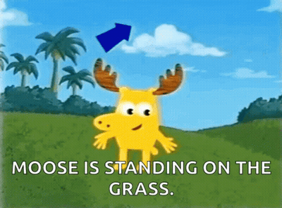 A Moose Is Standing On The Grass With A Blue Arrow Pointing To It GIF