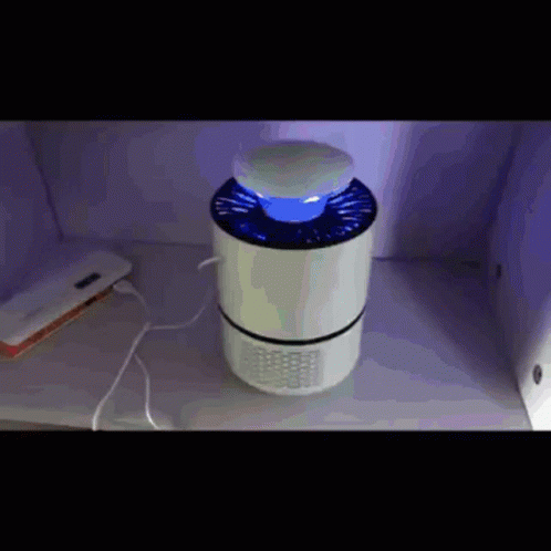 A Mosquito Killer Is Sitting On A Table Next To A Charger GIF